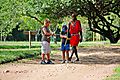 Masai Tribesman teaches young boys to make bows and arrows